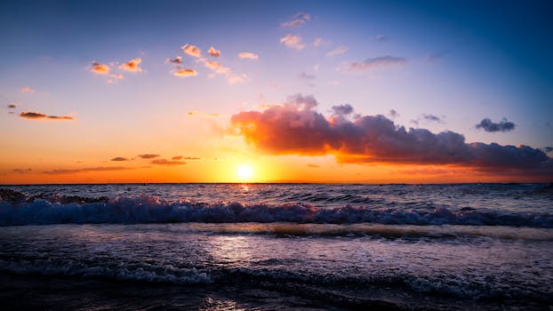 Capture the tranquility of a vibrant ocean sunset with colorful skies and gentle waves.