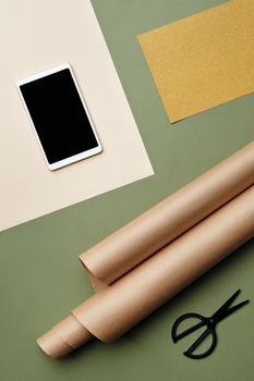 Artistic flat lay of craft supplies, including paper rolls, a smartphone, and scissors on a colorful background.. pexels, art