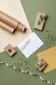 Minimalist flat lay of December-themed gift wrapping with craft paper and decorations.