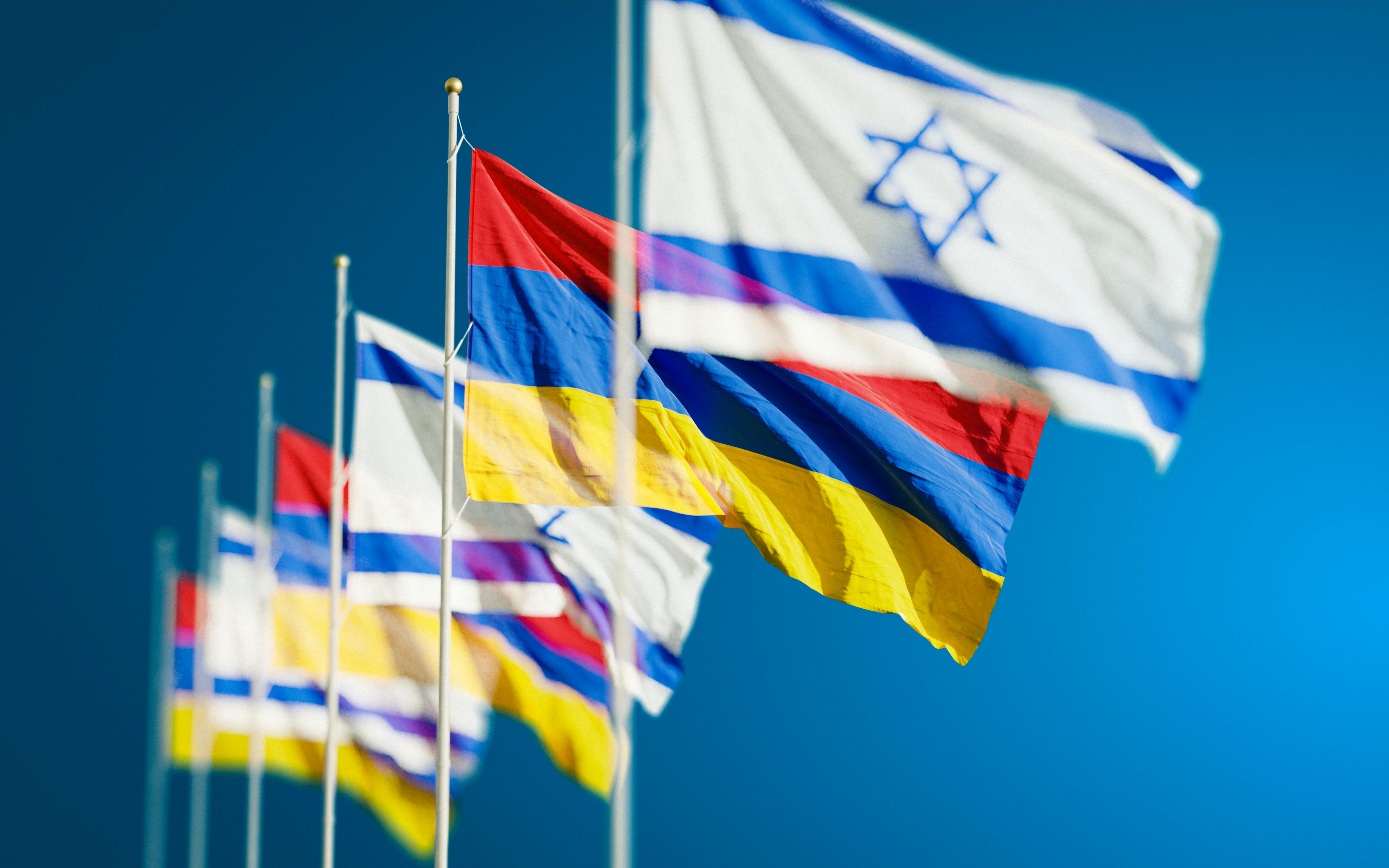 Armenia and Israel Flags against Blue Sky · Free Stock Photo