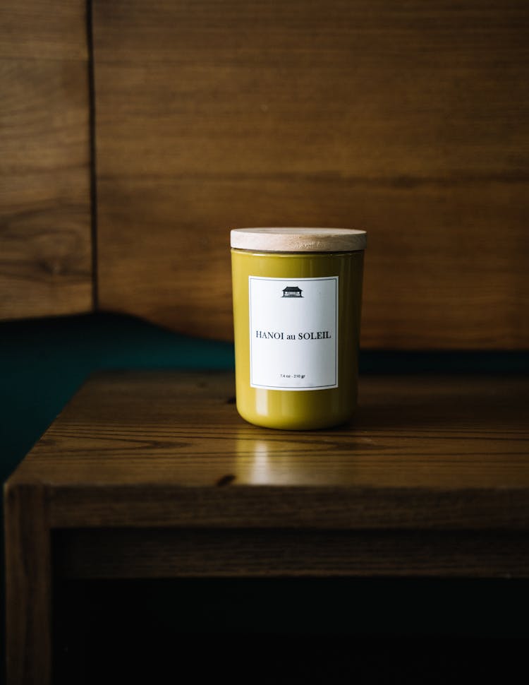 Scented Candle In A Glass Jar On The Wooden Table