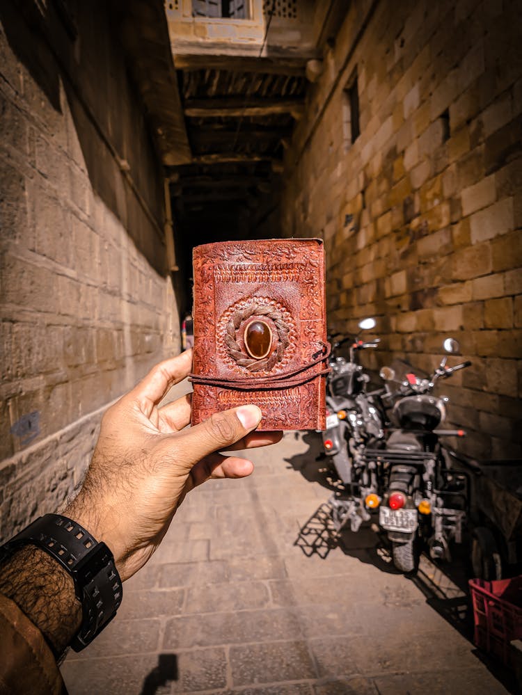 Man Holding Retro Leather Diary On Street Background