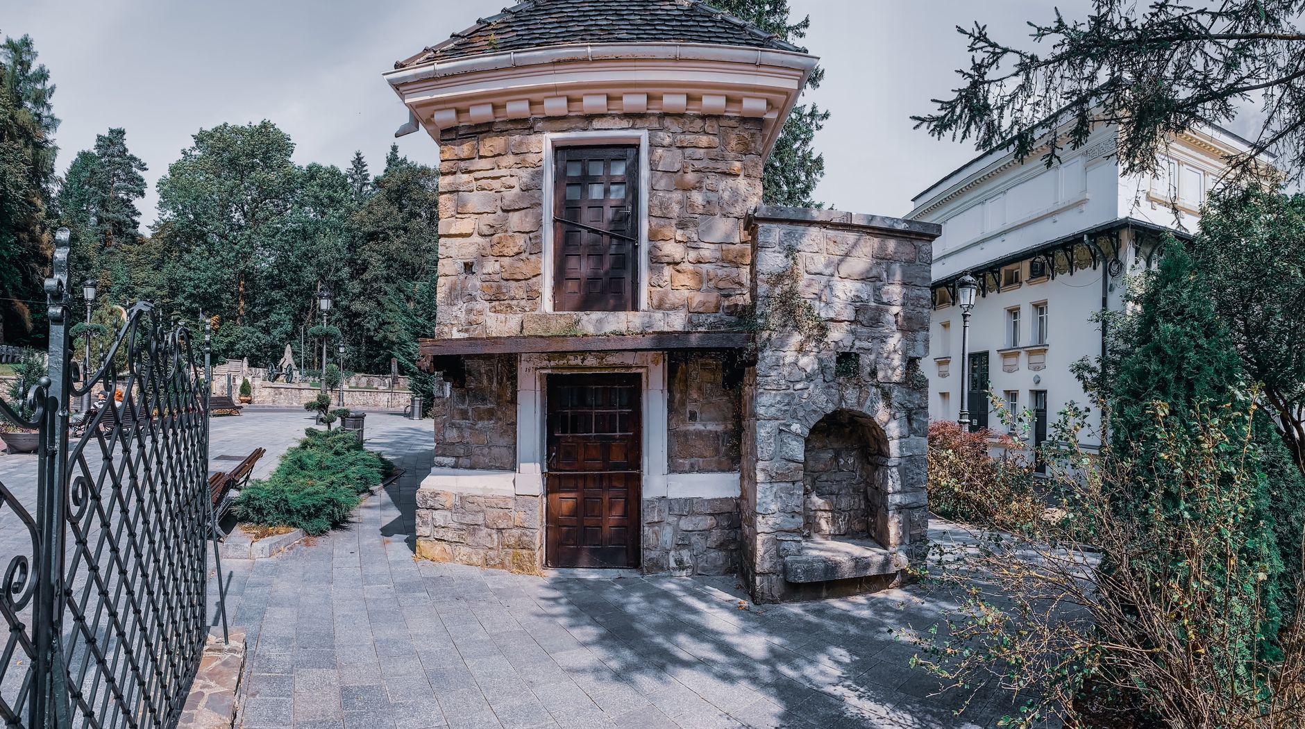 Restored stone house with wooden shutters and a vine-shaded courtyard in a Troodos village