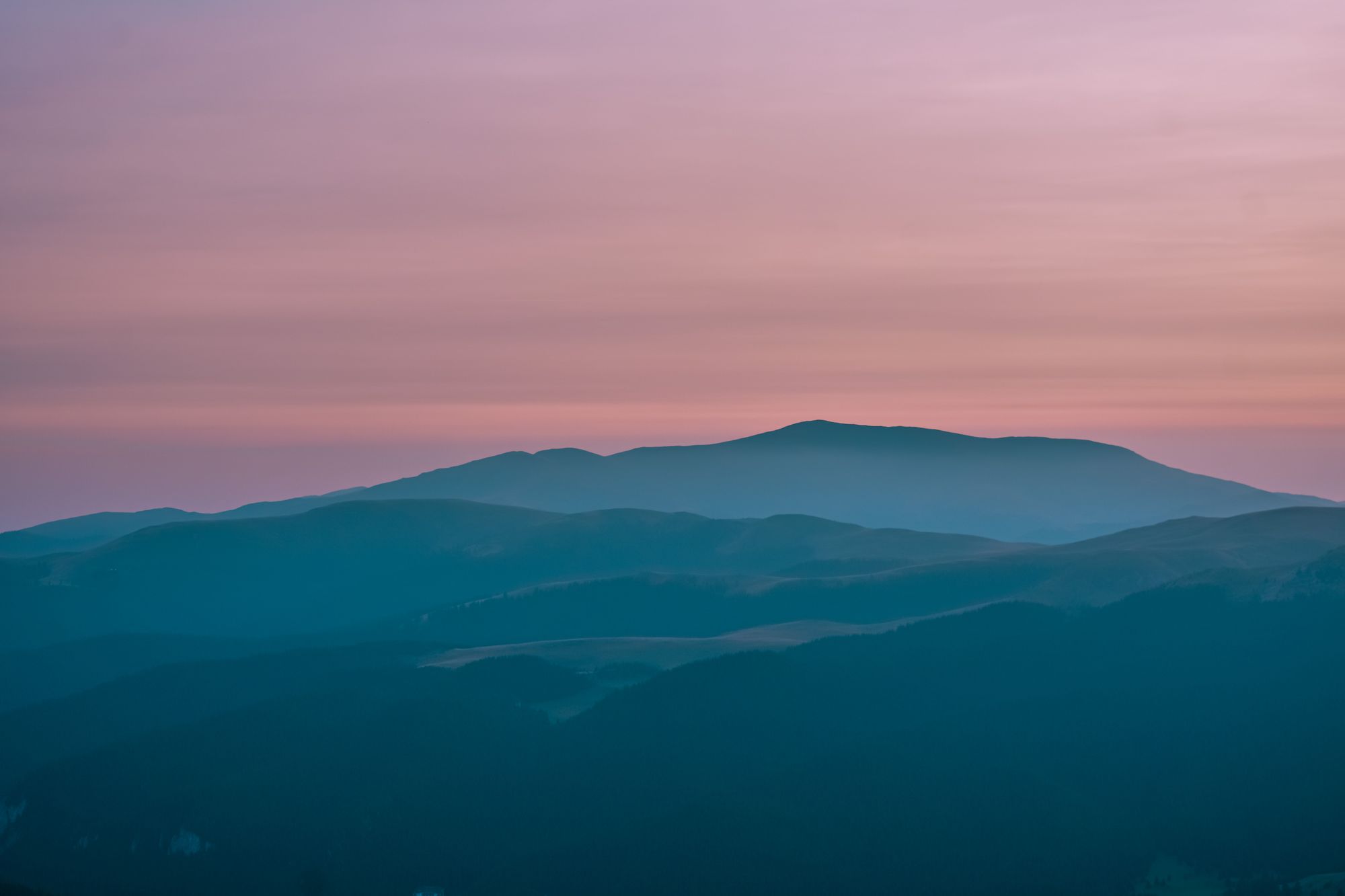 Misty mountain ridges under a soft pink dusk sky — Diana ✨ on Pexels