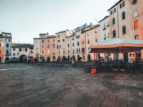 Free Light blue cloudless sky above people and outdoors cafe on paved square in daytime Stock Photo