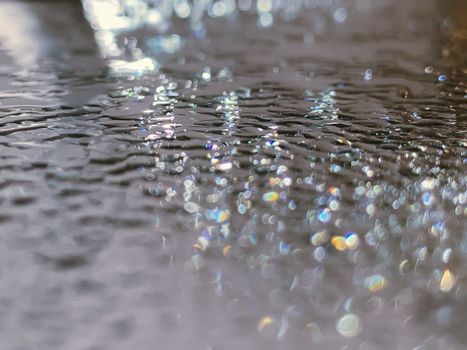 Selective focus of bright glistening tiny waves and ripples on water surface in daytime