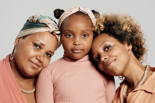 Women and a Child Looking at Camera