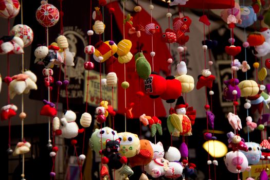 Vibrant Japanese ornaments hanging in a shop display, showcasing cultural artistry.