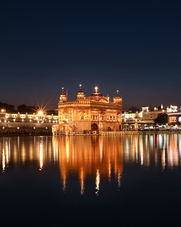 Old castle near reflecting water in dark