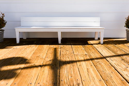 Free White Wooden Bench in Front of White Wall Stock Photo