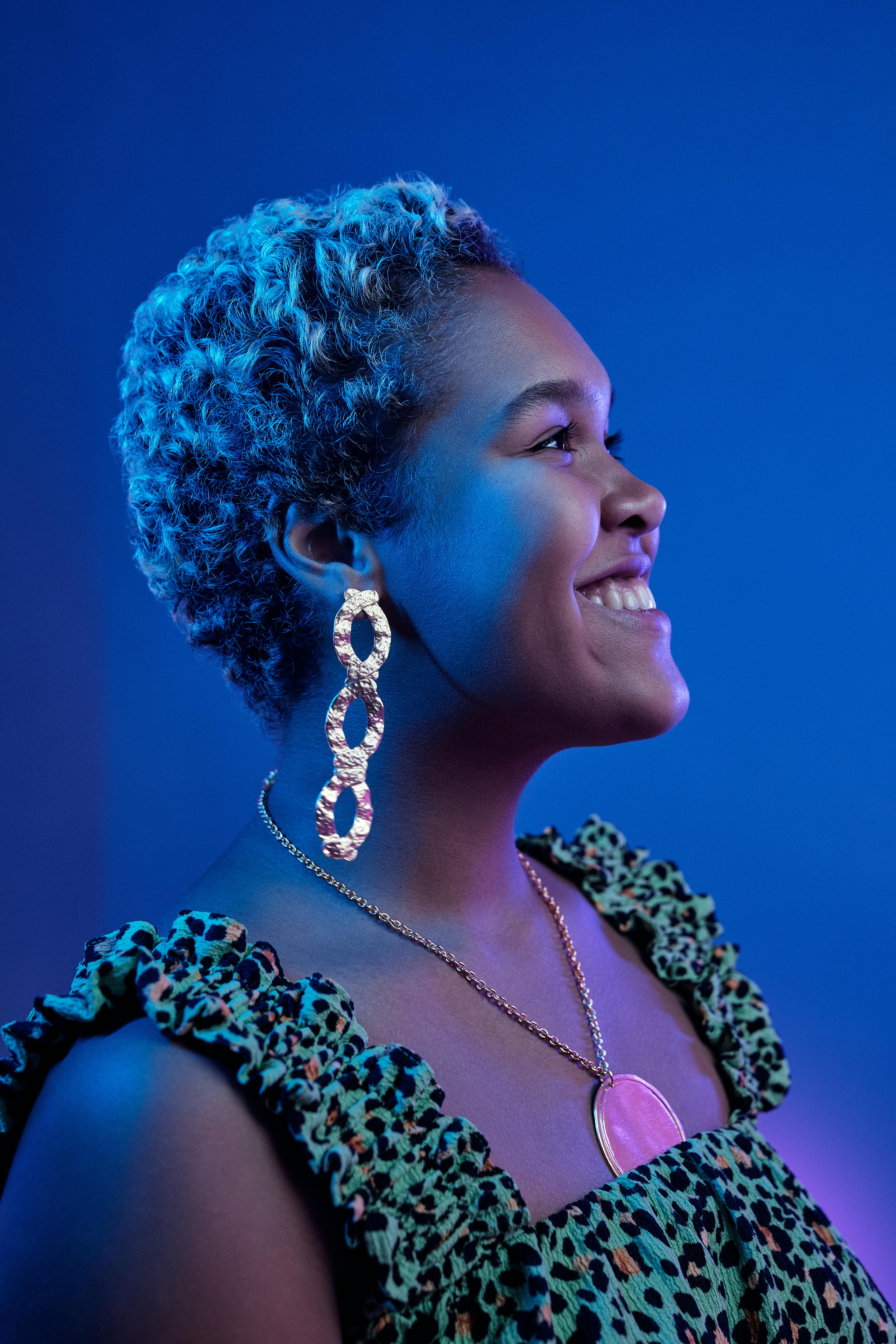 A Woman Wearing Gold Earrings and Necklace · Free Stock Photo