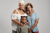 Studio portrait of a joyful family of three, expressing love and togetherness.