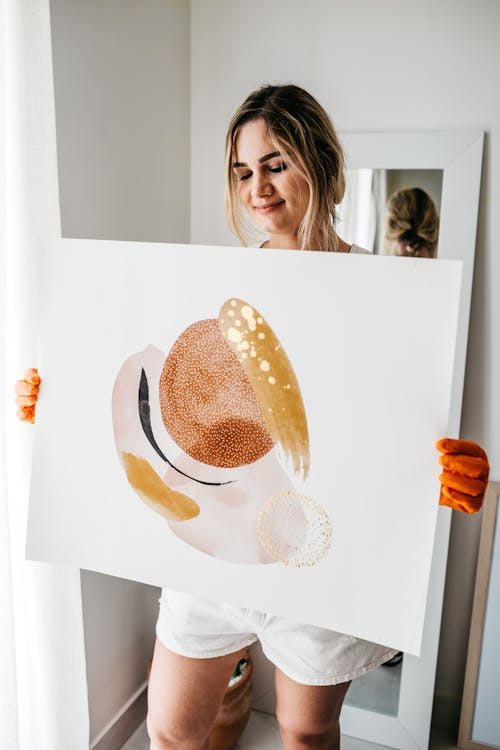 Happy woman carrying abstract picture