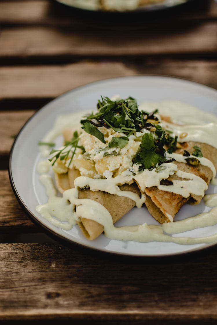 Close-up Of Pancakes With Dressing On Plate