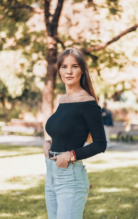 Off-shoulder black top with barrel jeans