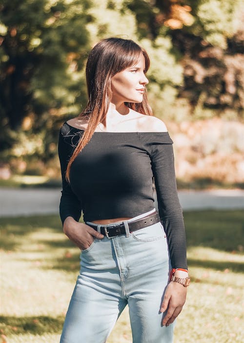 Woman in Long Sleeve Shirt Standing at the Park
