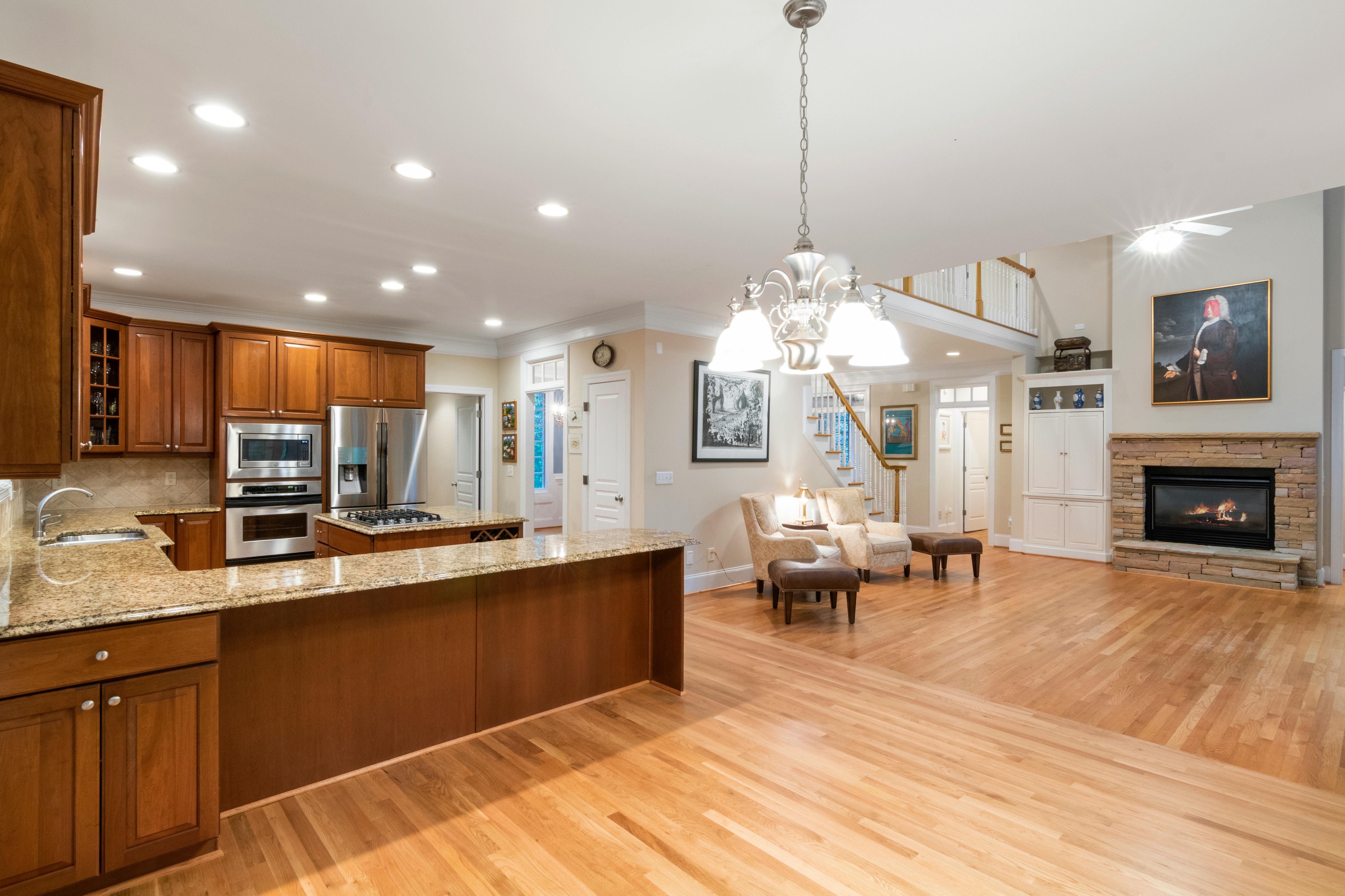 Elegant open-plan home interior with hardwood floors and modern kitchen.