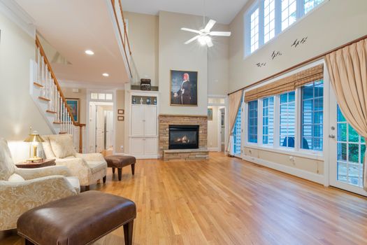 Spacious and elegant living room showcasing a modern fireplace and stylish decor.