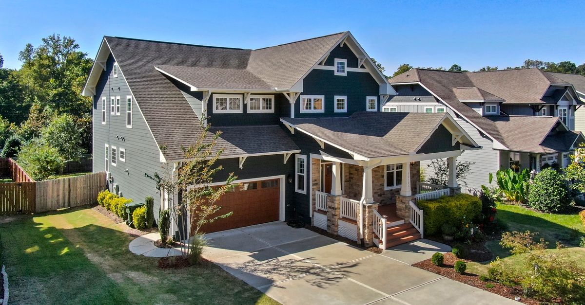 A beautiful Craftsman-style house with a spacious porch and manicured lawn in Raleigh, NC.