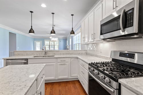 White Wooden Kitchen and Black Oven