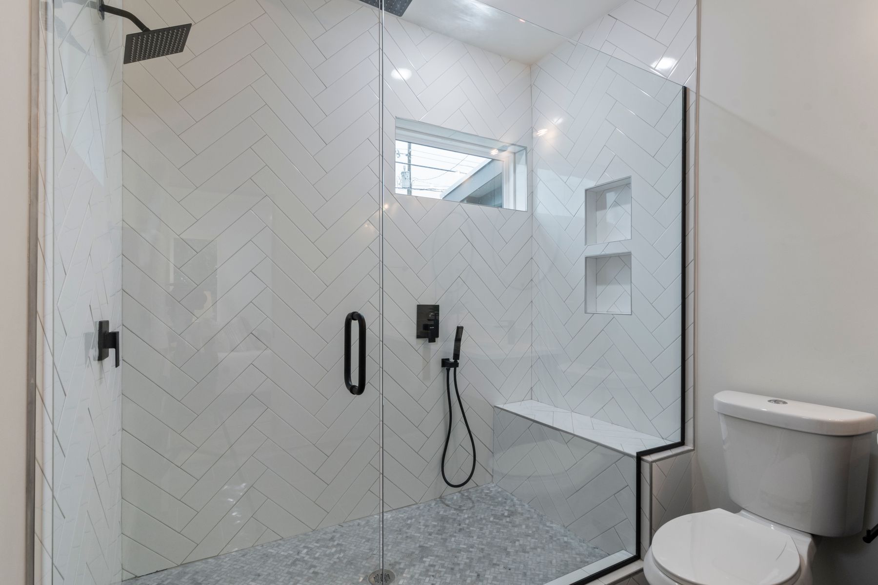 Spacious remodeled bathroom with a large walk-in shower and contemporary tile