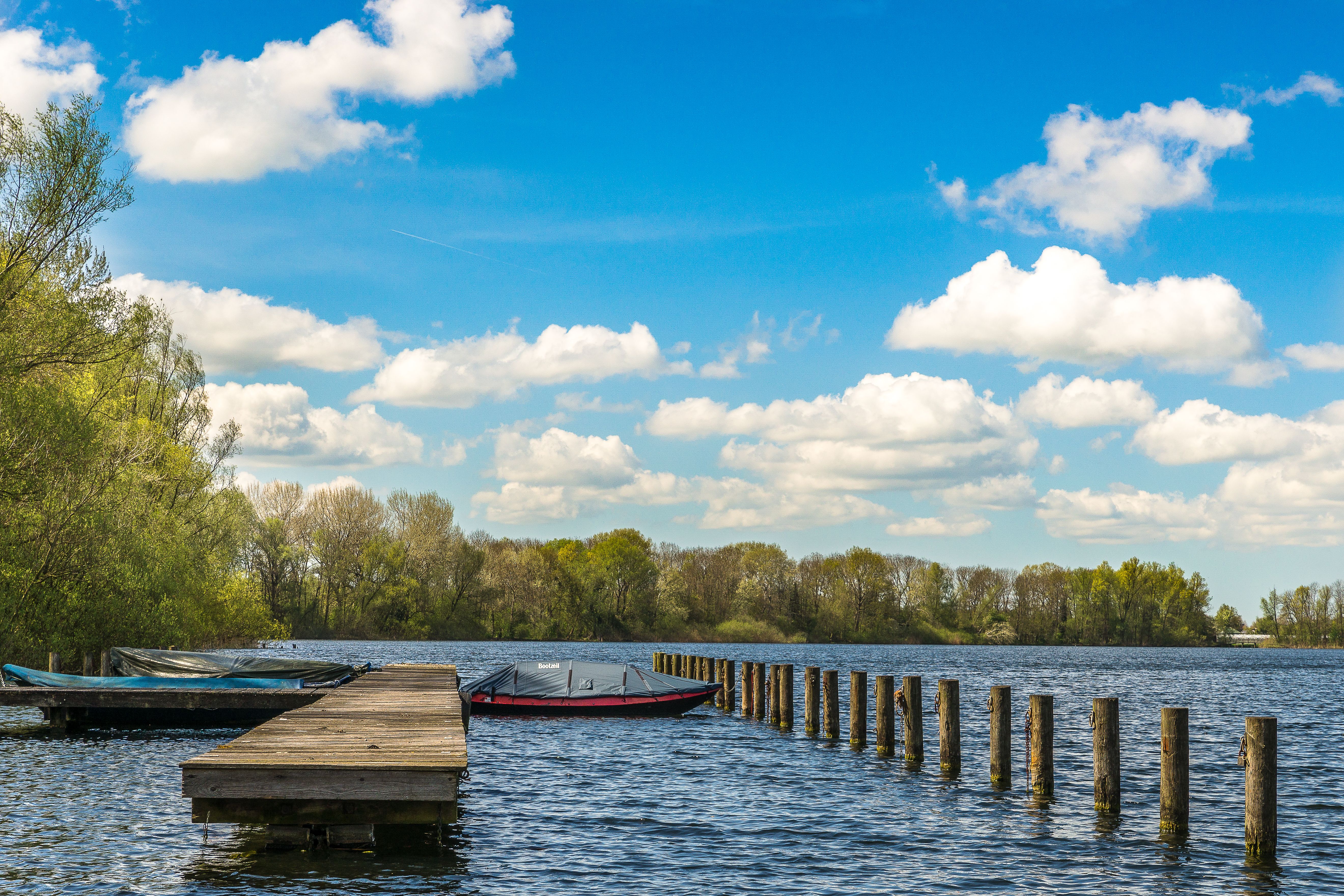 Wooden boat dock with boats on a calm Arkansas lake at sunset, the kind of lakefront dock Sugarloaf Soft Wash cleans around Greers Ferry Lake