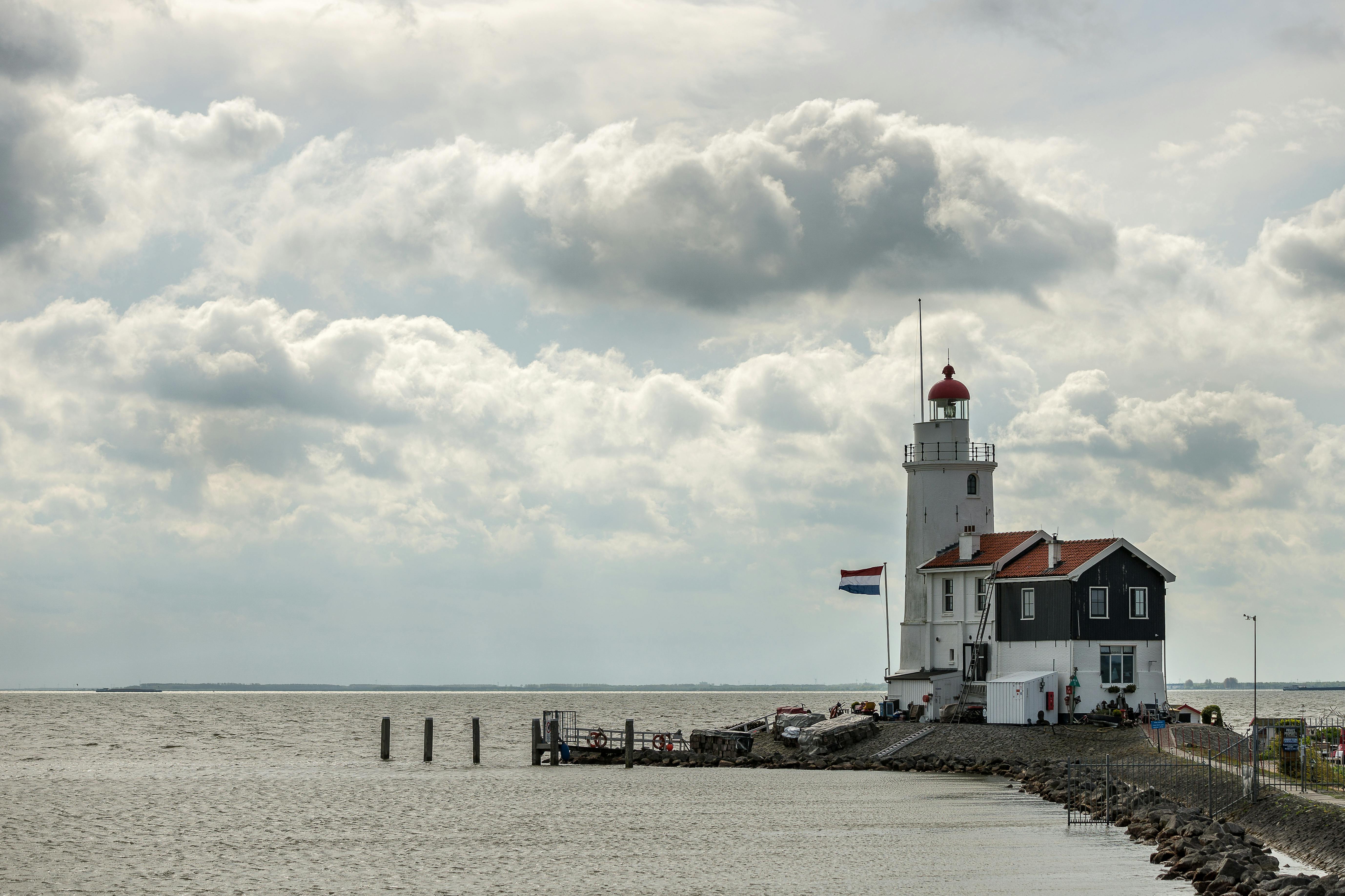 Brown and White Striped Lighthouse · Free Stock Photo