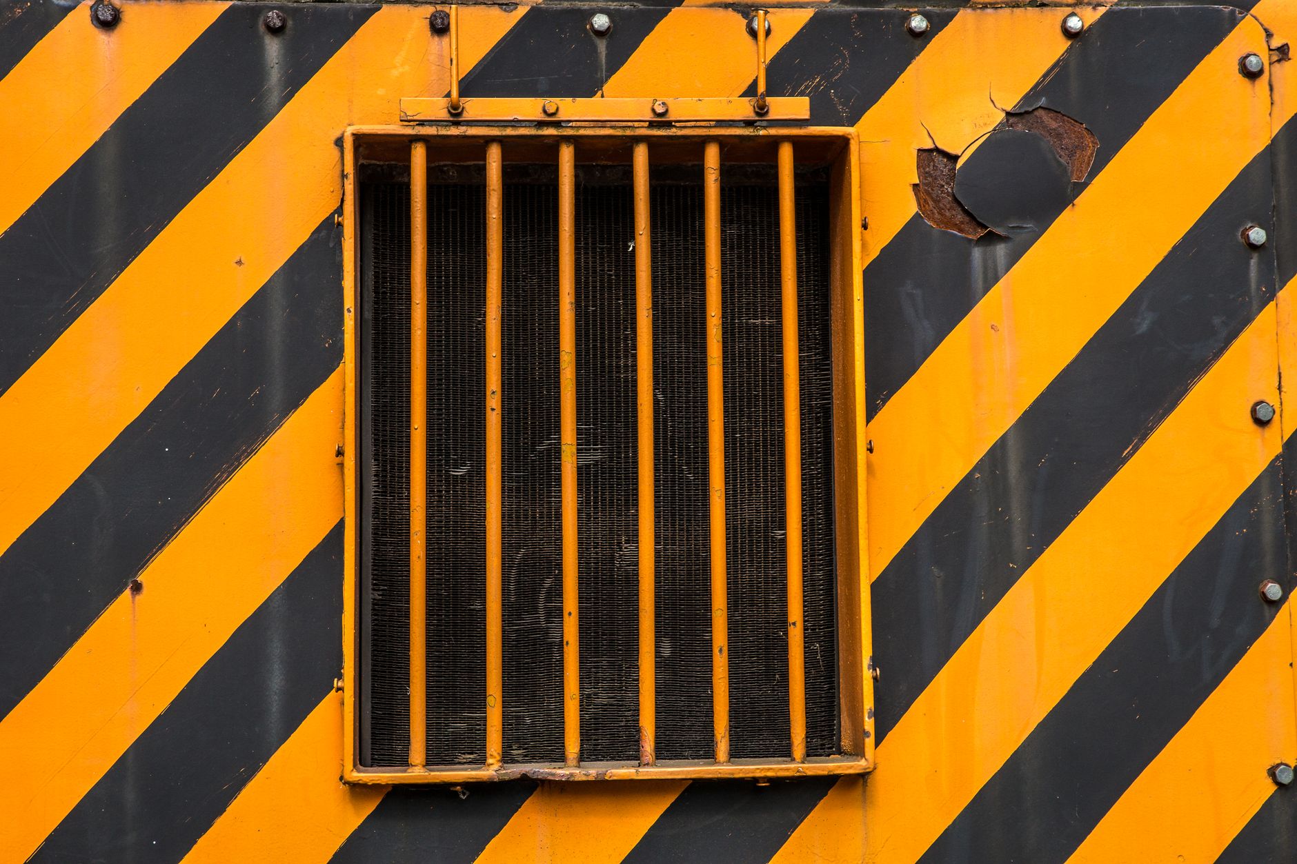 Window Safety for Kids: Practical Solutions from Home Depot Close-up of barred industrial window with yellow and black safety stripes