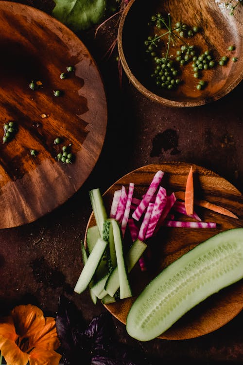 Sliced Fruits and Vegetables on a Wooden Plate