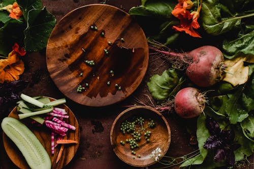 Sliced Fruits and Vegetables on a Wooden Plate