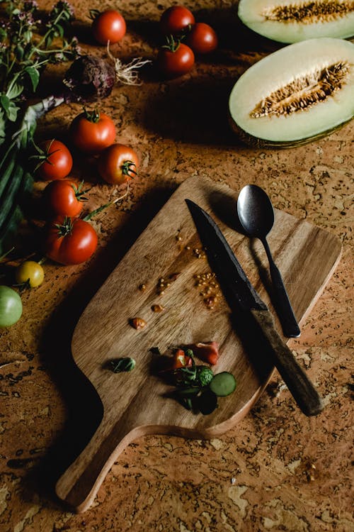 Free Kitchen Knife and Spoon on Wooden Chopping Board Stock Photo