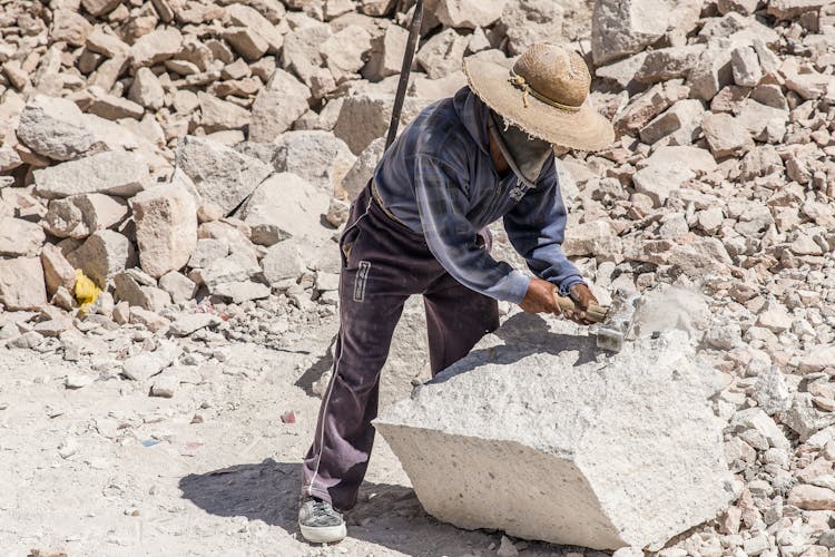 Quarry Worker Hammering Big White Stone