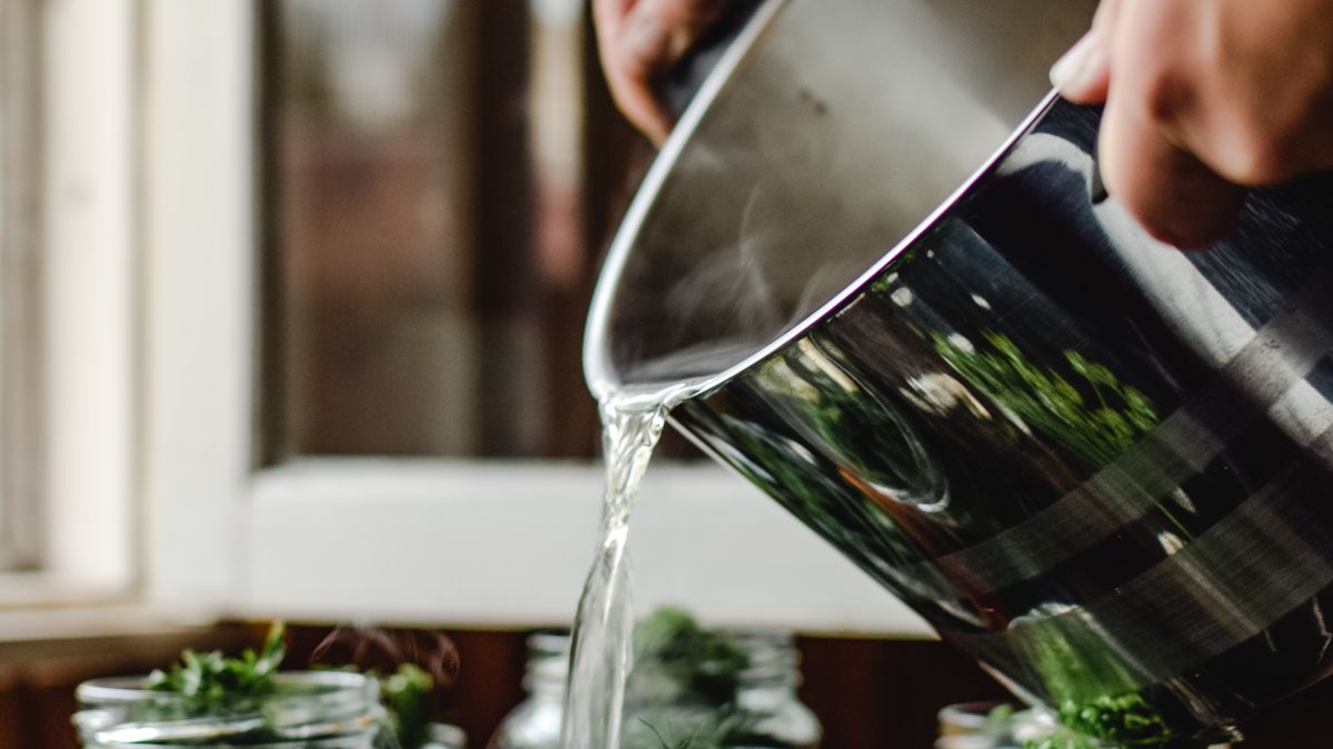 Fermented red onions in a glass jar with pink brine