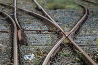 Brown Framed Eyeglasses on Brown Metal Train Rail