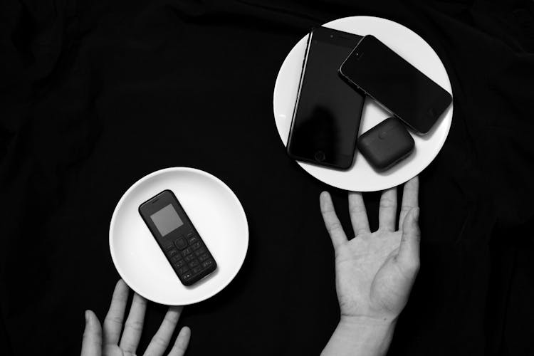 Phones On Plates And Hands