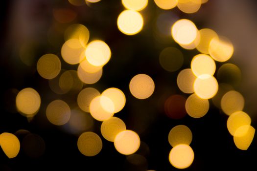 Abstract bokeh effect of warm yellow fairy lights, offering a festive, dreamy background.