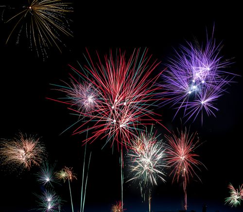 Free Colorful fireworks bursting against a dark night sky, symbolizing celebration and festivity. Stock Photo