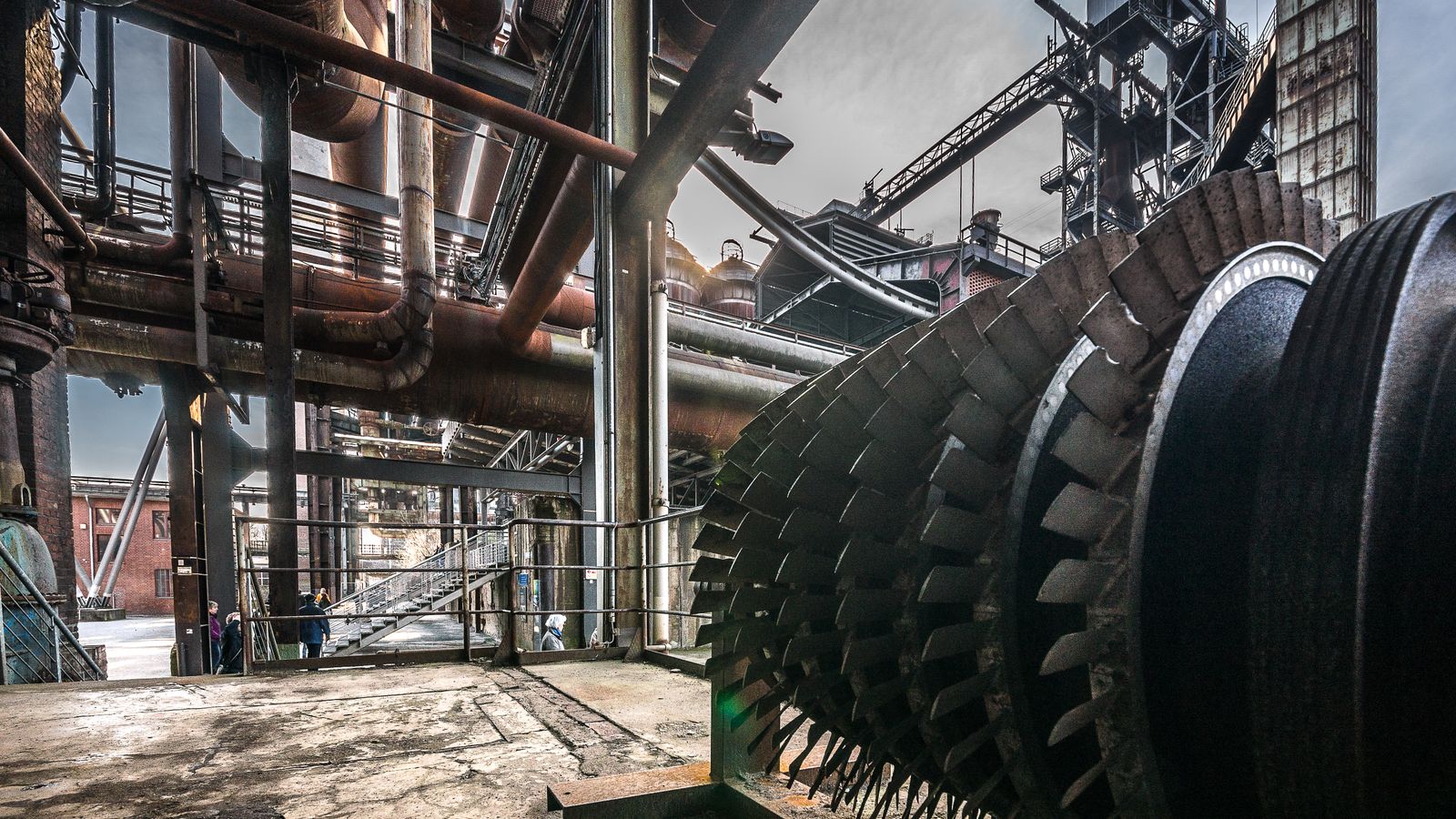 Heavy industrial machinery, steel structures and pipework inside a manufacturing facility — Bodi delivers industry-specific lubrication solutions across steel, cement, fleet, mining, metalworking and auto repair