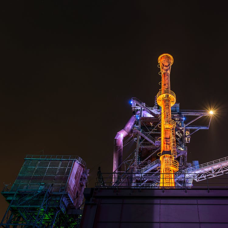 Factory Illuminated At Night