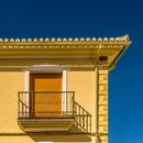 White Concrete Building With Yellow Window