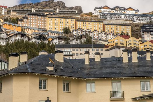 A view of densely packed residential buildings on a hillside, displaying diverse architectural styles.
