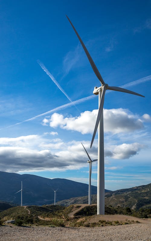 Wind Turbines in Valley against Blue Sky