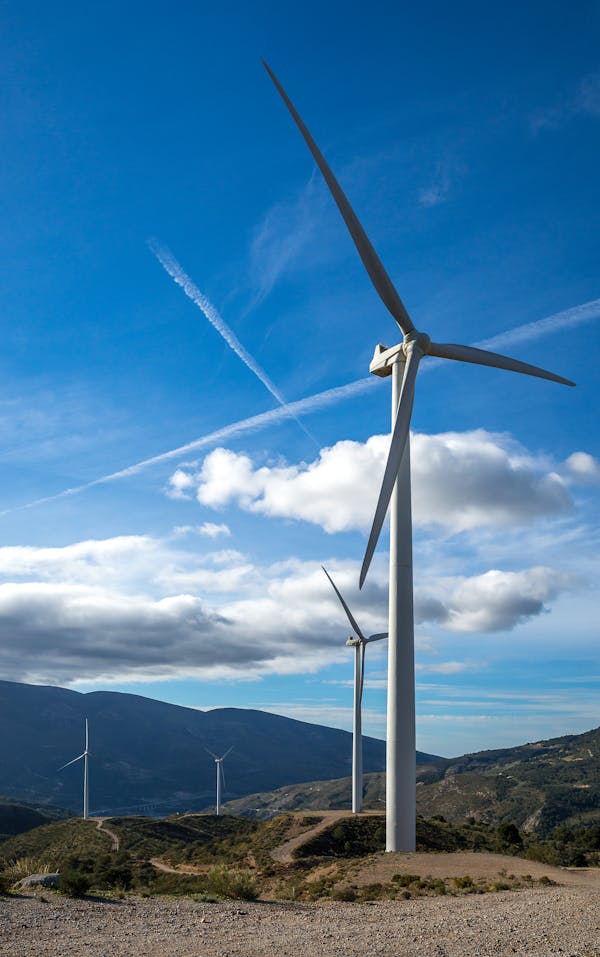 Wind Turbines in Valley against Blue Sky