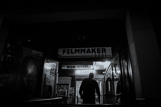 An individual enters a filmmaker-themed building at night, evoking a mysterious artistic vibe.
