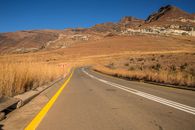 Road in Rocky Mountains and Dry Grass