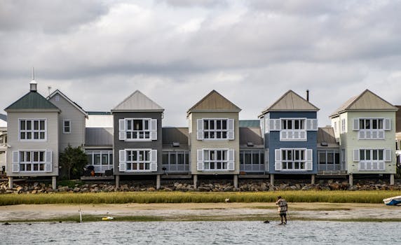 Picturesque row of colorful stilt houses on a serene beach front, ideal for relaxation.