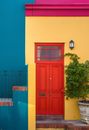 Red Wooden Door Beside Green Plant