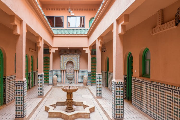 Pink Patio With Decorative Tiles And Fountain