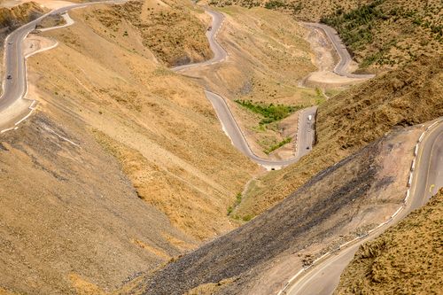 Free Captivating aerial photo of winding roads in a barren mountainous landscape, enhancing the natural texture and geology. Stock Photo