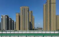 Brown Concrete Buildings Along the Road